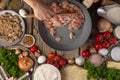 The cook prepares dumplings. The photo shows the process of mixing minced meat for dumplings. In the foreground are bright