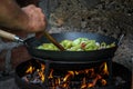 The cook prepares food in nature