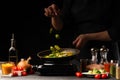Cook prepares for frying in a pan. Against the background of vegetables, falling brussels sprouts, freezing in motion
