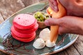 Cook prepares pink pancakes with honey, chocolate, jam, whipped cream, berries and fruits on plate. Royalty Free Stock Photo