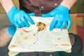 Cook prepares a shawarma. Ingredients in lavash