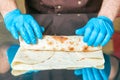 Cook prepares a shawarma. Ingredients in lavash.