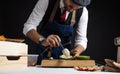 Cook preparing burger adding the sauce on green bun. Royalty Free Stock Photo