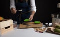 Cook preparing burger adding the sauce on green bun. Royalty Free Stock Photo