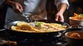 Cook preparing French Crepes in a pan