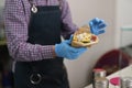 Cook preparing gyros wrap sandwich in a fast food restaurant. Male person cooking traditional Greek snack in a Mediterranean cafe Royalty Free Stock Photo