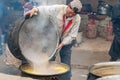 Cook preparing indian butter tea for buddhist ceremony in monastery