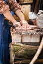 Cook is preparing a meal in the kitchen by filleting a fish with a knife. Royalty Free Stock Photo