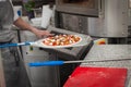 cook pulls lave baked pizza Royalty Free Stock Photo