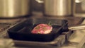 Cook Puts a Piece of Meat on the Grill Pan, Which Shrinks Instantly