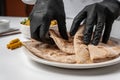 The cook puts whole-wheat tortillas on a white plate