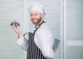 Cook in restaurant, uniform. Professional in kitchen. culinary cuisine. confident man in apron and hat hold tray. chef