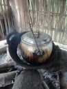 cook rice in the traditional way using a stone and wood-fired stove Royalty Free Stock Photo