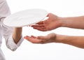 Cook's hand giving plate to man's hands Royalty Free Stock Photo