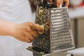 Cook`s hand grating apples for apple pie