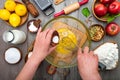 Cook's hands adding ingredients to glass bowl with whisk, Cooking pie dough top view. Cream with eggs in glass bowl