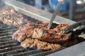 Cook`s hands with a knife check the readiness of the meat steak preparing Royalty Free Stock Photo