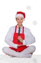 Cook in Santa Claus hat, yoga, knife under snow Royalty Free Stock Photo