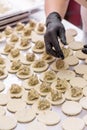 Cook sculpts dumplings. Production of dumplings and ravioli with various fillings