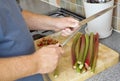 Cook sharpening knife over chopping board Royalty Free Stock Photo