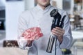 Cook shows a device for cooking at low temperatures and meat in a vacuum package Royalty Free Stock Photo