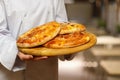 The cook shows a pitas on a wooden board Royalty Free Stock Photo