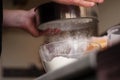 Cook sifting flour Royalty Free Stock Photo