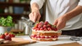 Cook slicing a Japanese strawberry short cake