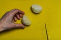 Cook slicing onions with a knife on a yellow cutting board