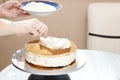 Cook spreads cream on the cake Royalty Free Stock Photo