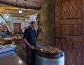 A cook stands near a large tray with a meat dish and waits for visitors in a roadside restaurant near the city of Wadi Musa in Jor