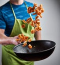 Cook throwing red prawns with a wok