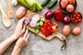 Cook vegetables. Hands cut pepper near autumn harvest on grey background top-down Royalty Free Stock Photo