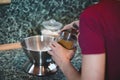 Cook weighs the sugar on an electronic scale to determine the exact weight. Adding a sweet flavour to the gingerbread dough.