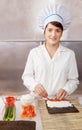 Cook woman making sushi rolls Royalty Free Stock Photo