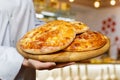 A cook on a wooden tray shows pitas Royalty Free Stock Photo