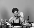 Cook works in kitchen near table with vegetables and tools Royalty Free Stock Photo