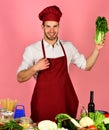 Cook works in kitchen with vegetables and tools. Royalty Free Stock Photo