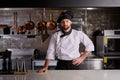 Cook young bearded man at kitchen restaurant