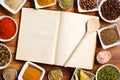 Cookbook and various spices and herbs. Royalty Free Stock Photo