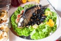 Cooked apetit dish beautifully decorated in a plate on a wooden table, natural light