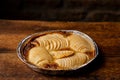 Cooked apple pie on wooden background. Finished semi-finished product