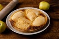 Cooked apple pie on wooden background. Finished semi-finished product