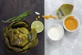 Cooked artichoke with two dips, background, half dark wood, hal