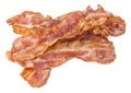 Cooked bacon rashers close-up isolated on a white background. Royalty Free Stock Photo