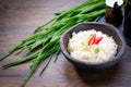 Cooked Basmati rice in a bowl on wooden table background. Boiled organic Basmati rice with seasoning and green onion. Asian dish Royalty Free Stock Photo