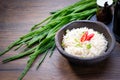 Cooked Basmati rice in a bowl on wooden table background. Boiled organic Basmati rice with seasoning and green onion. Asian dish