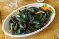 cooked boiled black mussels on wooden table