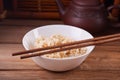 Cooked brown rice in white bowl with chopsticks on the wooden background Royalty Free Stock Photo