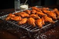 cooked buffalo wings on a cooling rack